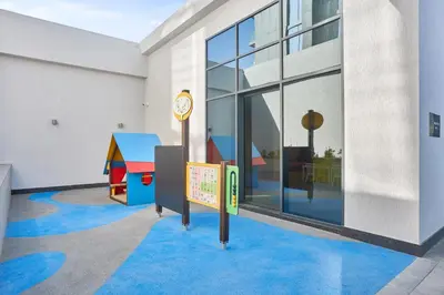 a room with a clock and a childrens play area at STAY BY LATINEM Luxury 1BR Holiday Home CVG 2409 Near Burj Khalifa in Dubai