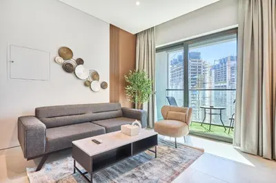 a living room with a couch and a table at STAY BY LATINEM Luxury 1BR Holiday Home CVG 2409 Near Burj Khalifa in Dubai