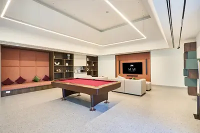 a pool table in a room with a tv at STAY BY LATINEM Luxury 1BR Holiday Home CVG 2409 Near Burj Khalifa in Dubai