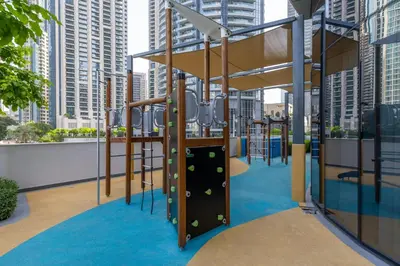 a playground in a city with tall buildings at Maison Privee - Sky-High Elegance with Unrivaled Burj Khalifa Views in Dubai