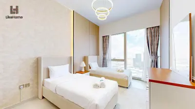 a hotel room with two beds and a window at Enjoy Best Burj Khalifa & Fountain Views From Balcony Luxury 2BR 3 Mins from Dubai Mall - Like Home in Dubai