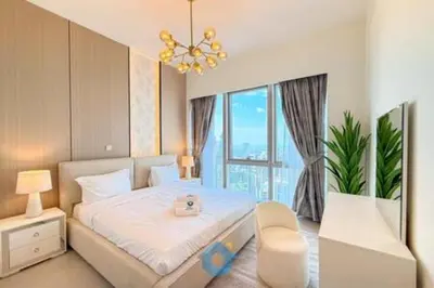 a bedroom with a bed and a large window at Next to Burj Khalifa & Dubai Mall - Enjoy Dubai Skyline Luxury 2BR Like Home in Dubai