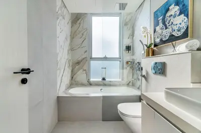 a bathroom with a tub and a toilet and a sink at GuestReady - Luxe Residence in Dubai Marina in Dubai