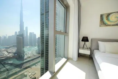 a room with a window with a view of a city at Silk Valley - Luxury 2B with iconic Burj Khalifa views and walk to Dubai Mall in Dubai