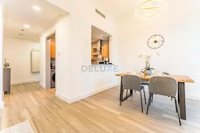 a dining room with a table and chairs and a clock at Terrace and Marina Views 1BR Near JBR, Ain Dubai and Major Landmarks, Zumurud, Dubai Marina by Deluxe Holiday Homes in Dubai