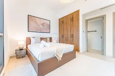 a bedroom with a large bed with a wooden cabinet at Terrace and Marina Views 1BR Near JBR, Ain Dubai and Major Landmarks, Zumurud, Dubai Marina by Deluxe Holiday Homes in Dubai