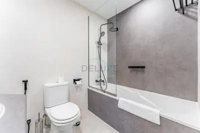 a bathroom with a shower and a toilet and a sink at Terrace and Marina Views 1BR Near JBR, Ain Dubai and Major Landmarks, Zumurud, Dubai Marina by Deluxe Holiday Homes in Dubai