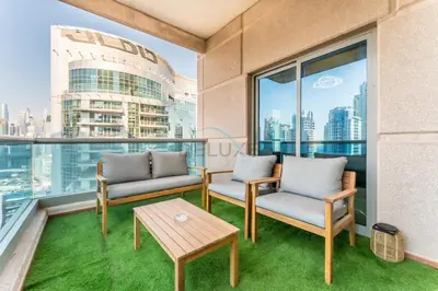 a balcony with two chairs and a table at Terrace and Marina Views 1BR Near JBR, Ain Dubai and Major Landmarks, Zumurud, Dubai Marina by Deluxe Holiday Homes in Dubai