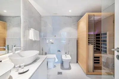 a bathroom with a tub and a sink and a toilet at Luxury 2BR Stay in DIFC, Steps to Gate Avenue and Dubai Mall in Dubai