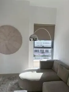 a living room with a couch and a table at Hideaway in Downtown in Dubai