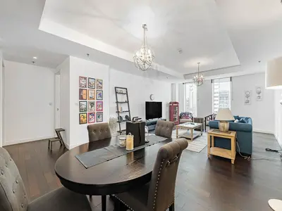 a living room with a dining room table and a couch at Short stay Limestone House DIFC 2 bedrooms in Dubai