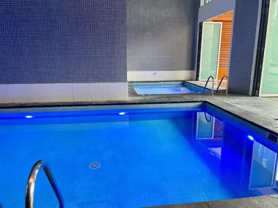 a large pool with blue water in a bathroom at Short stay Limestone House DIFC 2 bedrooms in Dubai