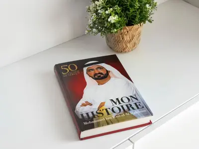 a magazine sitting on a table with a plant at Luxurious Home in the heart of Dubai Marina in Dubai