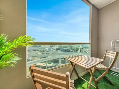 a balcony with a wooden table and chairs and a window at Luxurious Home in the heart of Dubai Marina in Dubai