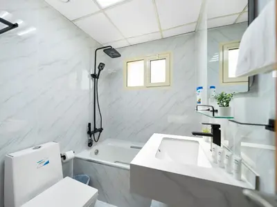 a white bathroom with a sink and a toilet at Luxurious Home in the heart of Dubai Marina in Dubai