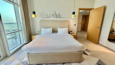 a bedroom with a large bed and a large window at Private Apartment in Novotel JVT Comfort for 4 Guests in Dubai