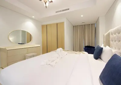a bedroom with a large white bed and a mirror at The Perfect Stay Paramount Business Bay 2BR in Dubai