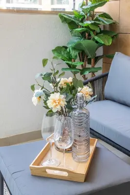 a tray with glasses and a bottle on a table at Frank Porter - Azizi Riviera 26 in Dubai