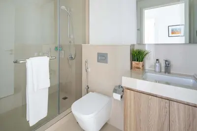 a bathroom with a toilet and a sink and a shower at Frank Porter - Downtown Views II in Dubai