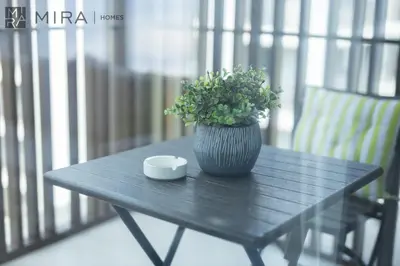 a black table with a plant and a cup on it at Mira Holiday Homes - Cosy 1BHK in the heart of Dubai Creek Harbour in Dubai