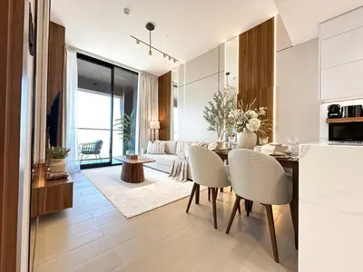 a kitchen and living room with a table and chairs at Trophy-Cultivate Retreat with Statement Design in Dubai