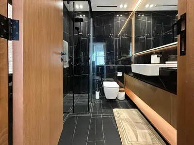 a bathroom with a shower and a toilet and a sink at Trophy-Cultivate Retreat with Statement Design in Dubai