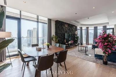 a living room with a table and chairs and a large window at RP Heights - Luxe 2BR with Burj Khalifa View - Zed Living in Dubai