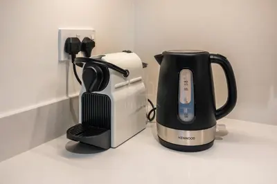 a coffee maker and a blender on a counter at Elegant 1 Bedroom in Orchid at Creek Beach in Dubai