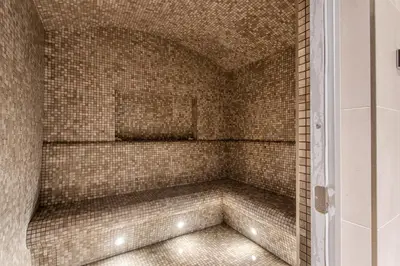 a bathroom with a shower with a tiled wall at STAY BY LATINEM Luxury 1BR Holiday Home W 3516 Near Burj Khalifa in Dubai