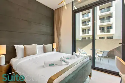 a bedroom with a large bed and a balcony at Urban Retreat Studio in The Autograph JVC in Dubai