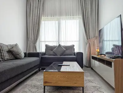 a living room with a couch and a coffee table at Stylish Fully Furnished 1BH Apartment Close by Dubai Science Park, Dubai Miracle Garden and Butterfly Garden in Dubai