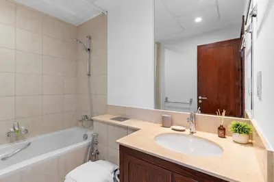 a bathroom with a sink and a tub and a toilet at Silkhaus Residences Towers 3BR Near Burj Khalifa in Dubai