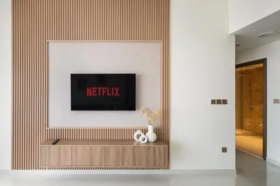 a living room with a tv on a wall at Beach View 1BR at Beachfront 50 Off Eid Offer in Dubai
