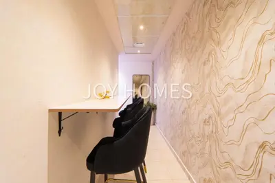 a room with a table and two black chairs at Amiralty Easy Stay in Dubai