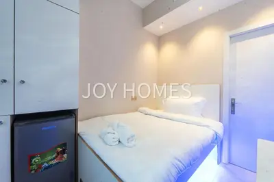 a bedroom with a bed with towels on it at Amiralty Easy Stay in Dubai