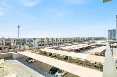 an overhead view of a parking lot with white stalls at GuestReady - Modern studio with balcony in Dubai in Dubai