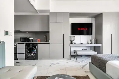 a kitchen with a washer and dryer in a room at GuestReady - Modern studio with balcony in Dubai in Dubai