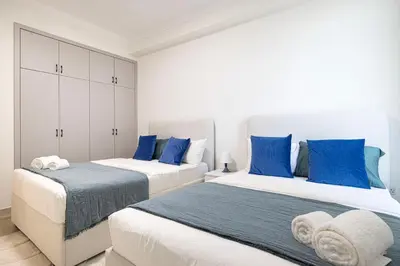 two beds in a room with blue and white at Prime Location - 2BR with Spectacular Sea View in Dubai