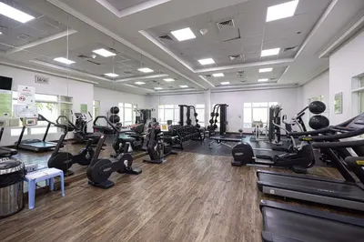 a gym with lots of treadmills and exercise equipment at Prime Location - 2BR with Spectacular Sea View in Dubai