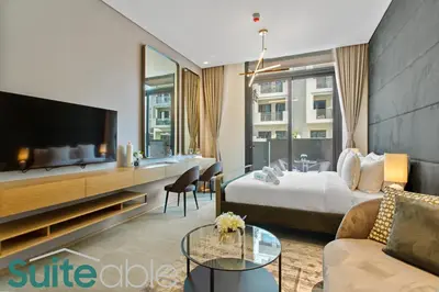 a hotel room with a bed and a tv at Studio in The Autograph JVC w amazing facilities in Dubai