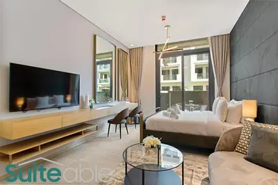 a living room with a bed and a tv and a couch at Studio in The Autograph JVC w amazing facilities in Dubai