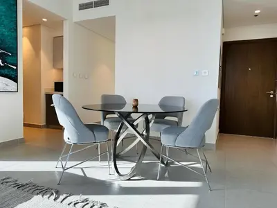 a dining room with a table and four chairs at Your Home away from Home in Dubai