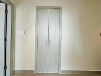 a white closet with two doors in a room at Your Home away from Home in Dubai