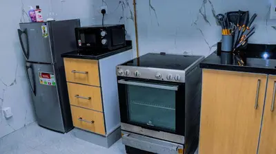 a kitchen with a stove and a refrigerator at Luxurious holiday homes in Dubai