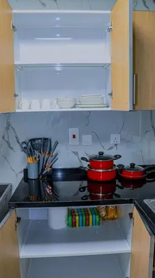 a kitchen with two pots and pans on a stove at Luxurious holiday homes in Dubai