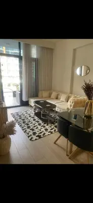 a living room with a couch and a table at Azizi riviera in Dubai