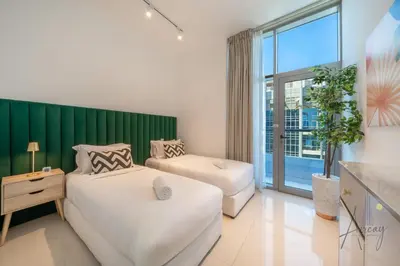 a bedroom with two beds and a green wall at Stunning Views Spacious 3BR Dubai Marina in Dubai
