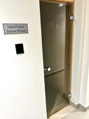 a bathroom with a shower with a sign that reads subway sauna room at Vibrant studio - 15m to marina in Dubai
