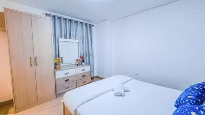a bedroom with a bed and a dresser and a mirror at Luxurious Studio Apartment in Dubai