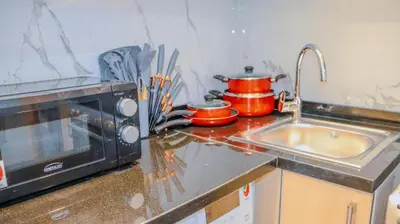 a kitchen counter with a sink and a microwave at Luxurious Studio Apartment in Dubai